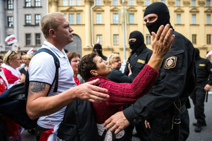 Protesters speak with Belarusian special police officers at Sunday's rally to protest against disputed presidential election