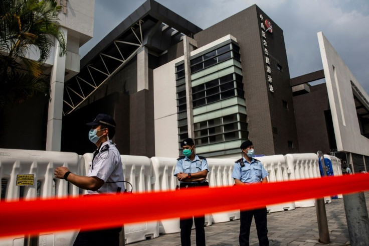 Hong Kong police patrol outside a sports complex that will be used as a coronavirus testing centre