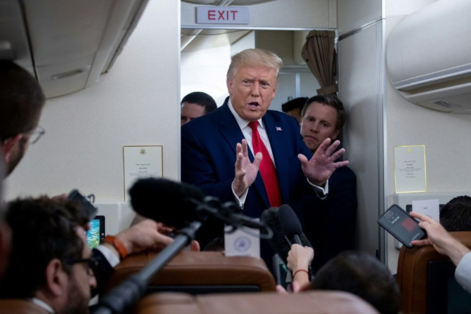 US President Donald Trump speaks with reporters aboard Air Force One on August 28, 2020