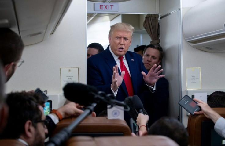 US President Donald Trump speaks with reporters aboard Air Force One on August 28, 2020