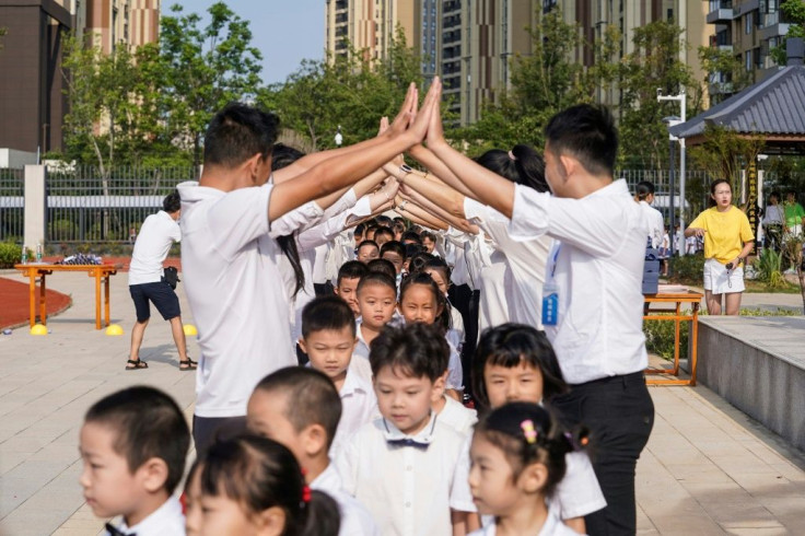 Teachers gave pupils an honour guard as they arrived at school in Wuhan for the first time in seven months