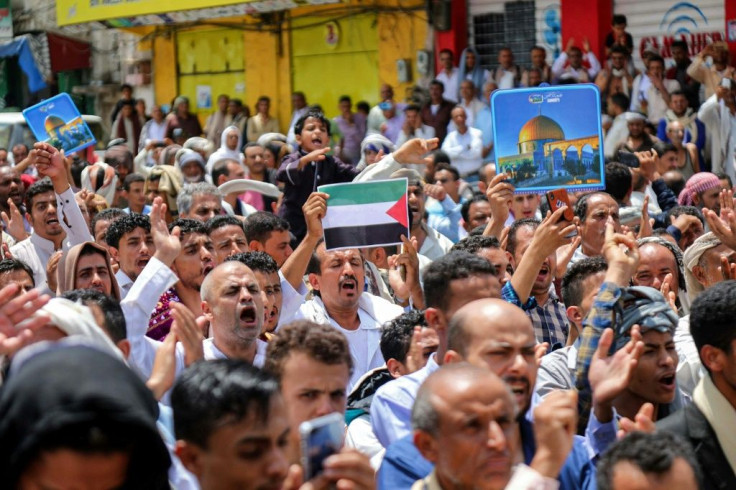 Demonstrators chant slogans with signs depicting Jerusalem's Dome of the Rock and flags of Palestine during a protest in Yemen on August 21 against the US-brokered deal between the United Arab Emirates and Israel to normalise relations