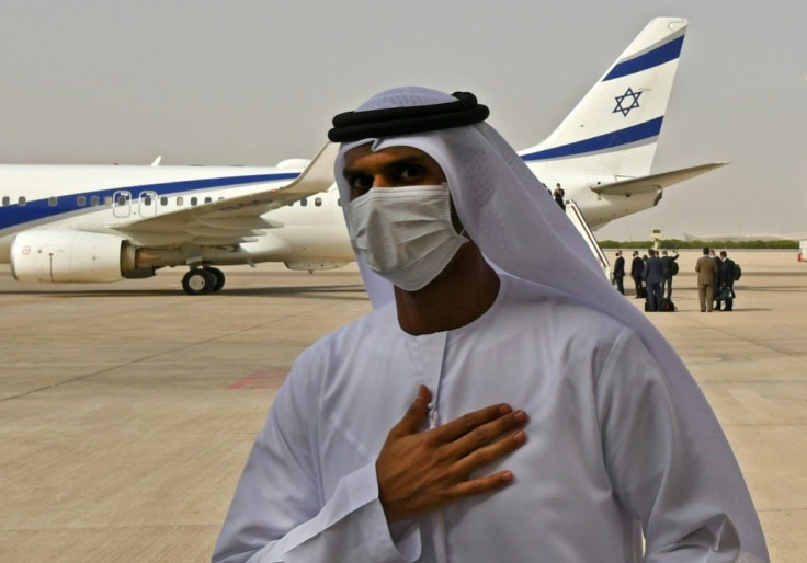An Emirati official stands near the El Al plane that flew the first-ever direct commercial service from Israel to the UAE