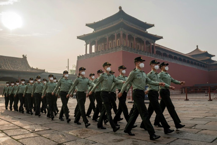 People's Liberation Army (PLA) soldiers march next to the entrance to the Forbidden City in Beijing