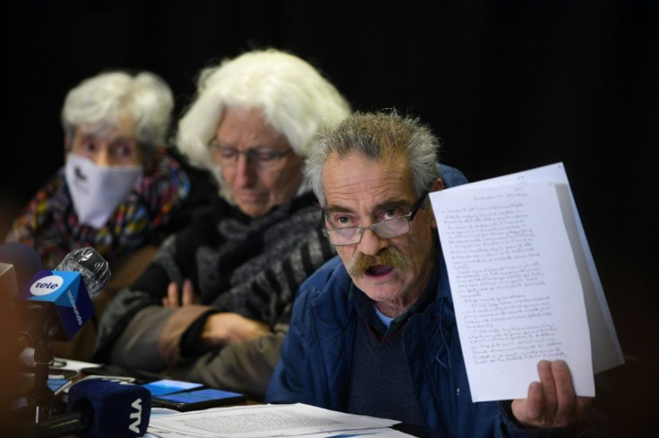 Ignacio Errandonea, member of Madres y Familiares de Desaparecidos organization, holds part of a copy of an Army's honor court document about retired Colonel Gilberto Vazquez, in prison for human rights abuses during the 1973-1985 dictatorship in Uruguay,