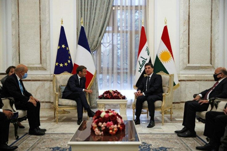 Macron (C-L) meets with President of Iraq's Kurdistan Region Nechirvan Barzani (C-R), in the Iraqi capital Baghdad on Wednesday