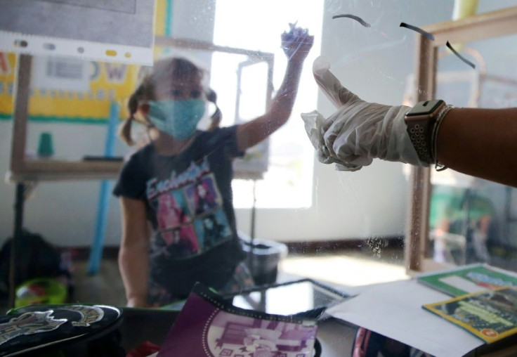 A student at a socially distanced protective desk in California, one of the US states hit hardest by the coronavirus