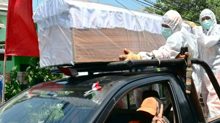 Indonesian officials in hazmat suits parade empty coffins through the streets of Jakarta to remind residents that coronavirus cases are still surging in one of Asia's worst-hit nations.