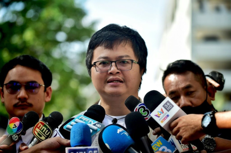 Human rights lawyer Anon Numpa speaks to the media as he arrives at the Criminal Court to answer charges of violating his bail terms in Bangkok