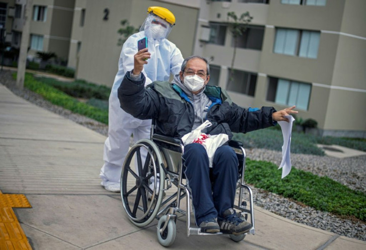 Cesar Sayan, 73, who has recovered from Covid-19, gestures as he leaves the temporary hospital set up in the former Athletes Village for the 2019 Pan American Games in Lima