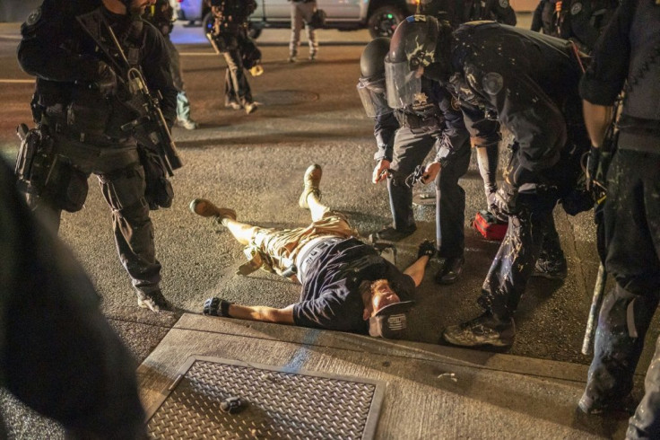 Police treat a man who was shot near a pro-Trump rally on August 29, 2020 in Portland, Oregon