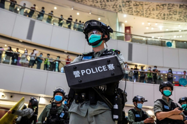 A riot police officer stands guard in a shopping mall in Hong Kong in July after the new national security law was introduced in the city