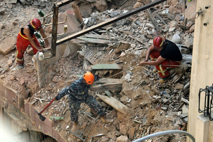 Rescue workers dig through the rubble of a badly damaged building in Lebanon's capital Beirut in search of a possible survivor from a mega-blast at the adjacent port one month ago, after scanners detected a pulse, on September 4, 2020
