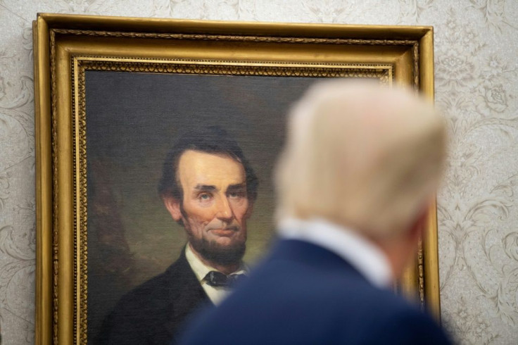 President Donald Trump looks at a portrait of Abraham Lincoln in the White House in August 2020