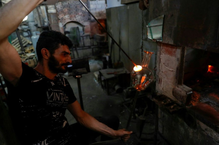 A glass blower shapes traditional water pitchers at the Uniglass factory in Tripoli, north Lebanon, where glass broken in the Beirut port explosion is being repurposed