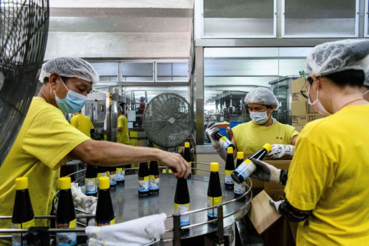 At the Koon Chun Sauce Factory workers are scrambling to cover hundreds of thousands of bottles with new 'Made in China' labels