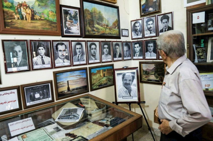 Omar Farhadi, an elderly Iraqi Kurd, views photos of Jewish teachers at the Museum of Education in Arbil's oldest primary school in northern Iraq