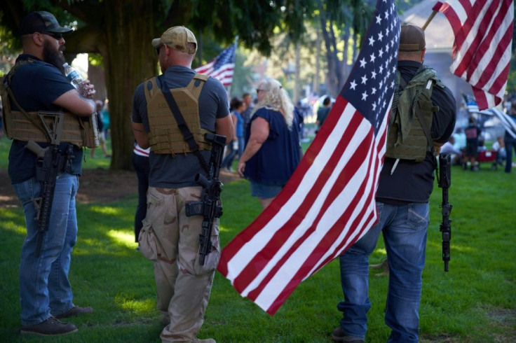 Armed men and supporters of Patriot Prayer gather in Esther Short Park for a memorial for member Aaron Danielson in Vancouver, Washington