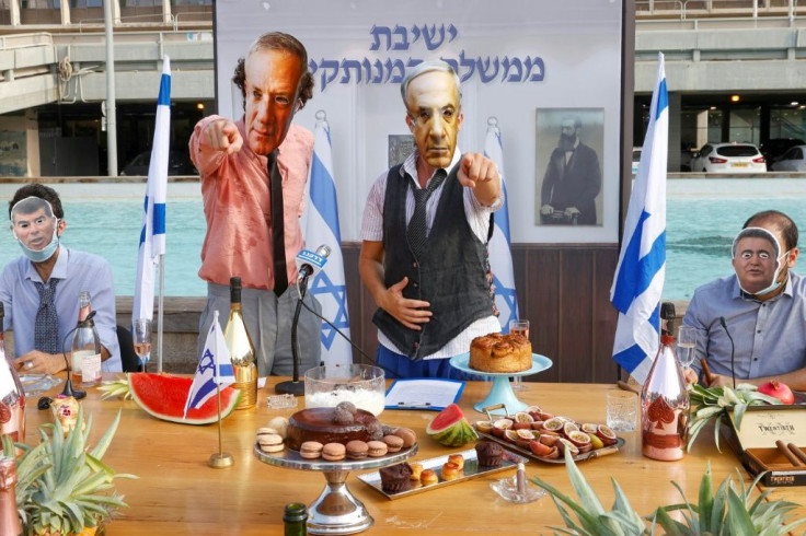 Israeli comedians, wearing masks bearing the portraits of leaders including Prime Minister Benjamin Netanyahu, stage a fake cabinet meeting protesting the government's  handling of the Covid-19 pandemic