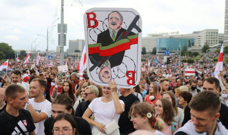 Many protesters held red-and-white flags and placards while a band beat drums and played other instruments