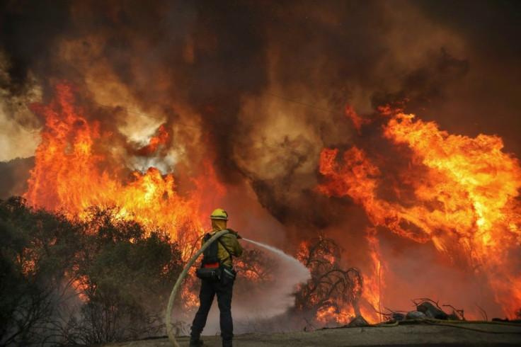 San Miguel County Firefighters battle a brush fire along Japatul Road during the Valley Fire in Jamul, California
