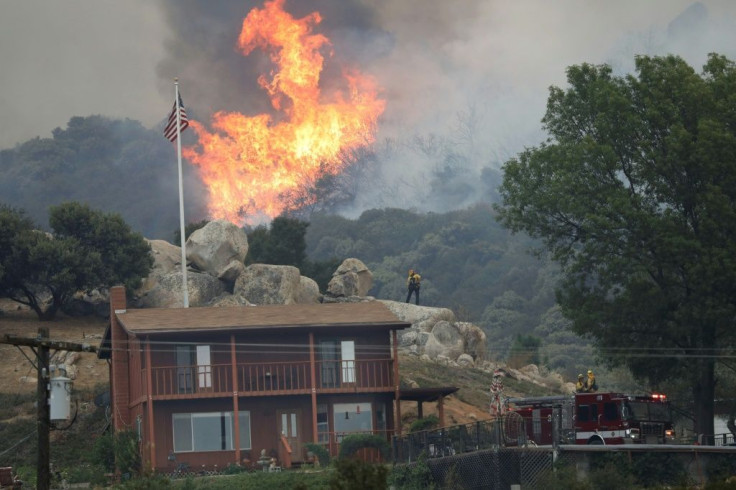 A brush fire encroaches along Japatul Road during the Valley Fire in Jamul, California