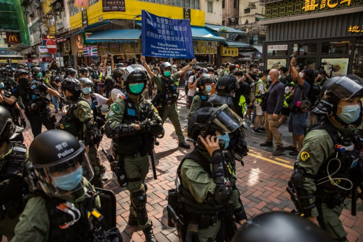 Hundreds of riot police flooded the Mong Kok district of Kowloon in a bid to thwart online calls for flash mob protests to mark the suspended vote