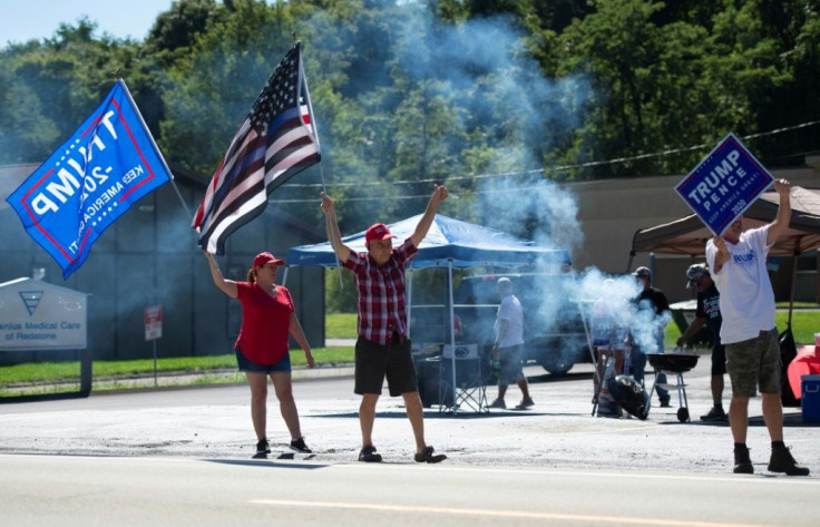 Supporters of US President Donald Trump wield signs and flags as they hold a Republican voter registration in Brownsville, Pennsylvania