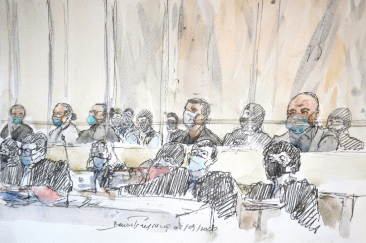Some of the accused in the courtroom watched the images, while others looked away