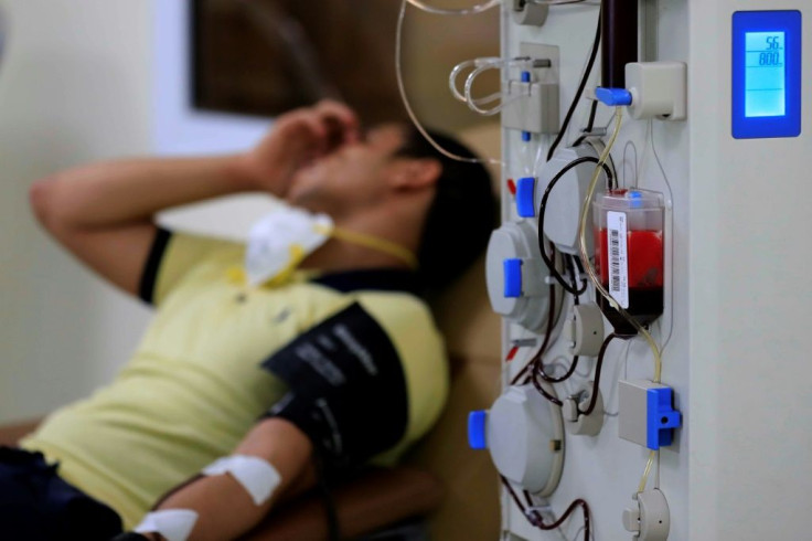 An Egyptian man who recovered from Covid-19 donates blood at the National Blood Transfusion centre in Cairo