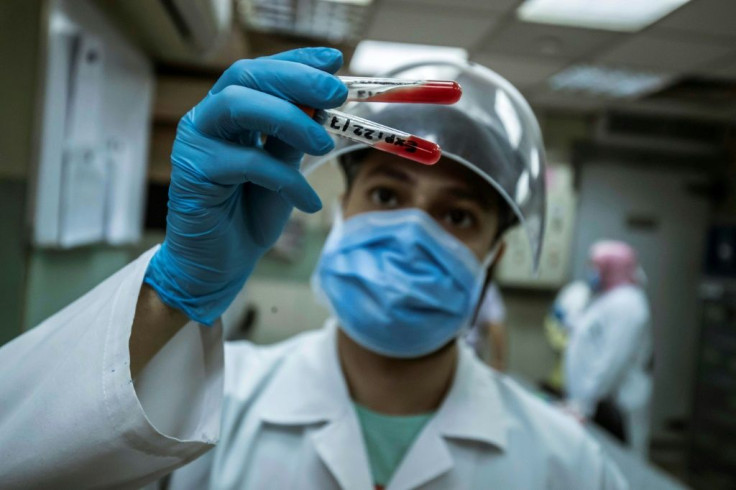 An Egyptian medical worker checks blood donated from a person who recovered from Covid-19 inless at the National Blood Transfusion centre in Cairo