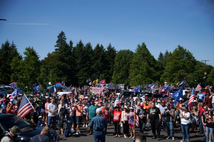 Hundreds of Donald Trump's supporters gathered for a large motorcade in support of the US president and police near Portland, where anti-racism activists have clashed continuously with law enforcement for more than 100 days