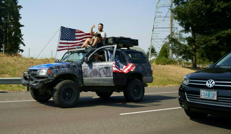 About 300 cars, including many massive pickup trucks, then took to the roads surrounding Oregon City, some 30 miles (50 kilometers) from Portland, before dispersing