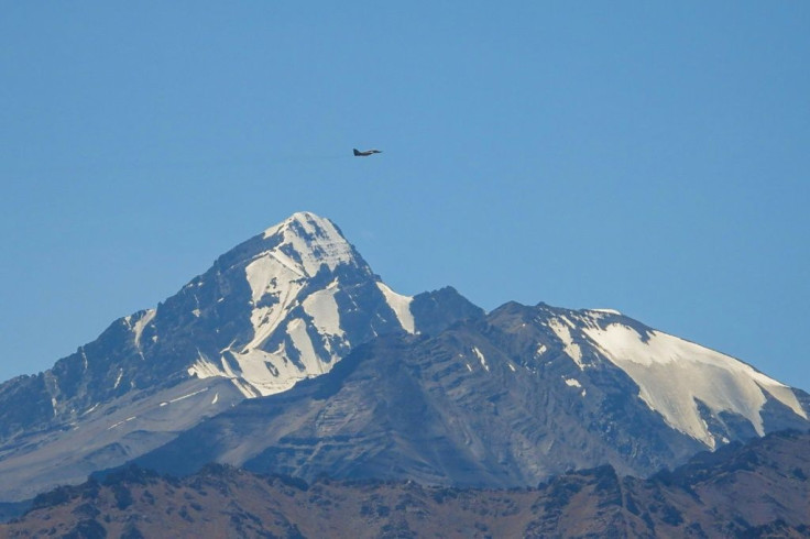 An Indian fighter flies over mountains near the border with China, where military tensions have escalated since clashes in June