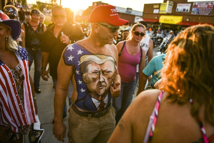 A man walks down Main Street in Sturgis, South Dakota, showing off his chest painted with a portrait of President Donald Trump during the 80th Annual Sturgis Motorcycle Rally on August 7, 2020