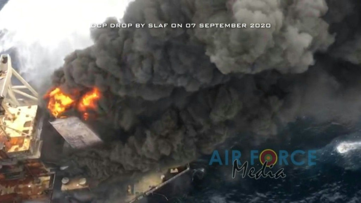 Footage from the Sri Lankan Air Force shows helicopters on Monday dropping bags of dry chemical powder to try to put out a fresh fire on a stricken oil tanker off the coast of Sri Lanka