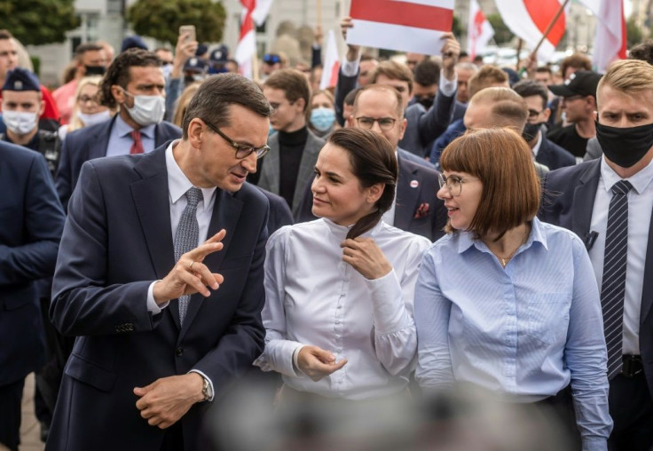 Exiled opposition leader Svetlana Tikhanovskaya walks with Polish Prime Minister Mateusz Morawiecki after telling Warsaw university students events in Belarus were 'historic'