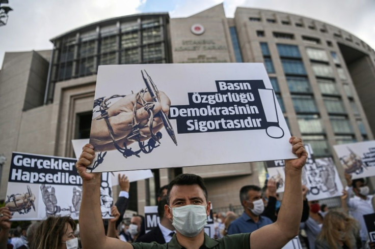 Demonstrators rallied outside the Turkish court with posters calling for press freedom