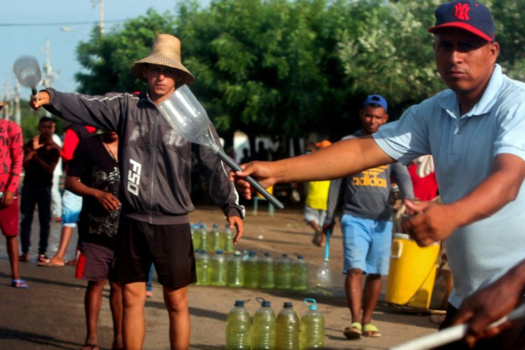Men offering gasoline for sale on the streets of Maracaibo amid flourishing sales of fuel smuggled in from Colombia in August 2020