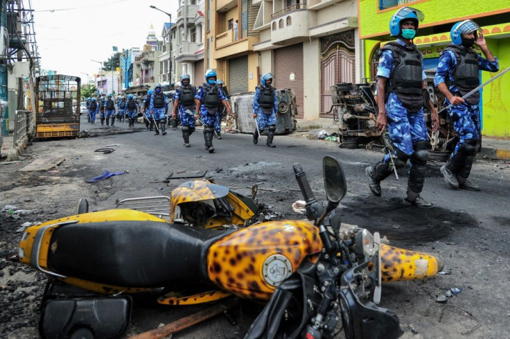 Rapid Action Force (RAF) personnel patrol on a street of Devara Jevana Halli in Bangalore on August 13, 2020, after a "derogatory" Facebook post about the Prophet Mohammed sparked riots