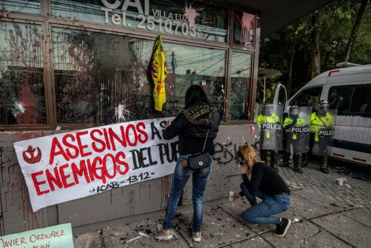 "Murderers, enemies of the people" reads the sign placed at a police station following deadly protests in Bogota