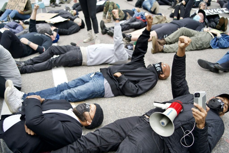 Protesters outside the Hennepin County Family Justice Center in Minneapolis as four former police officers accused of  killing George Floyd appeared inside