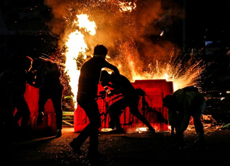 Demonstrators set a barricade on fire during a protest against police brutality in Cucuta, on Colombia's border with Venezuela