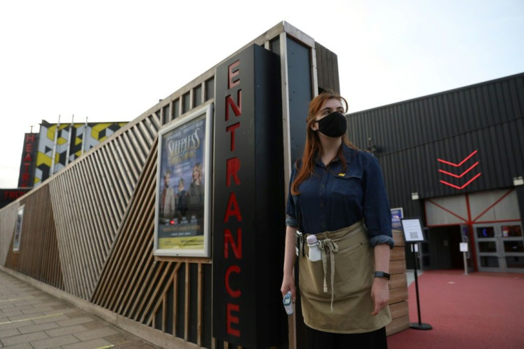 Members of the audience have their temperatures taken and are told to wear face masks throughout the performance