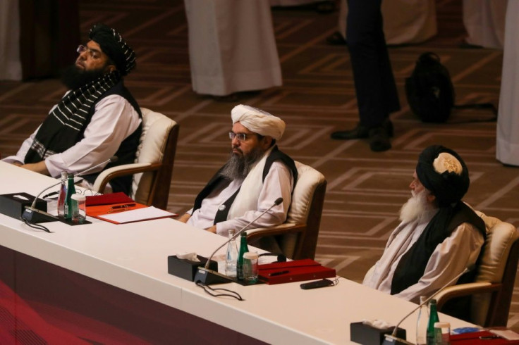Members of the Taliban delegation attend the opening session of peace talks with the Afghan government