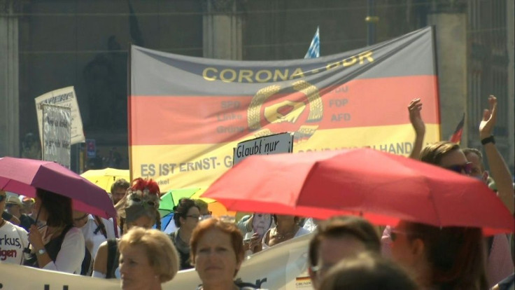 IMAGES In Munich, corona skeptics gather to march against coronavirus restrictions adopted by the German authorities, waving German flags and holding placards against Chancellor Angela Merkel.