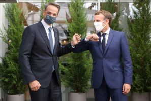 French President Emmanuel Macron, pictured with Mitsotakis, has supported Greece in the row with Turkey