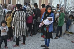 Refugees and migrants wait for medical assistance at a new MSF clinic near Kara Tepe camp