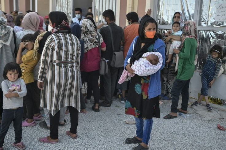 Refugees and migrants wait for medical assistance at a new MSF clinic near Kara Tepe camp