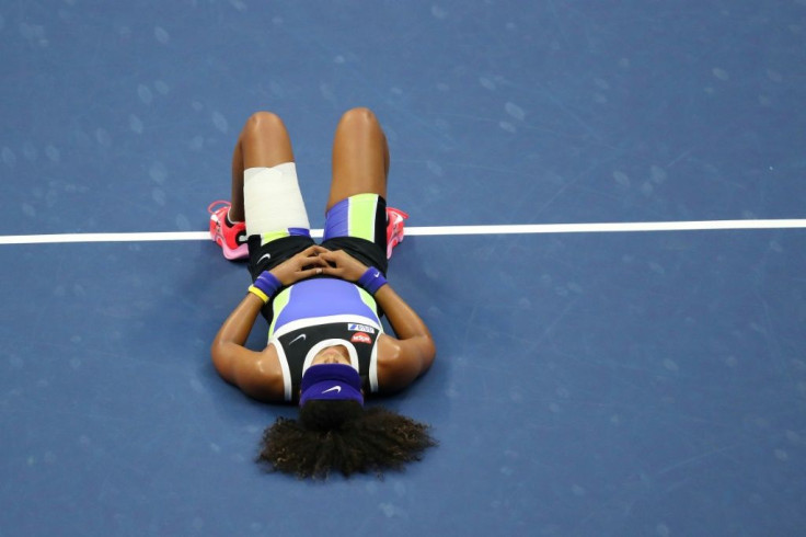 Naomi Osaka of Japan lays down in celebration after winning the 2020 US Open